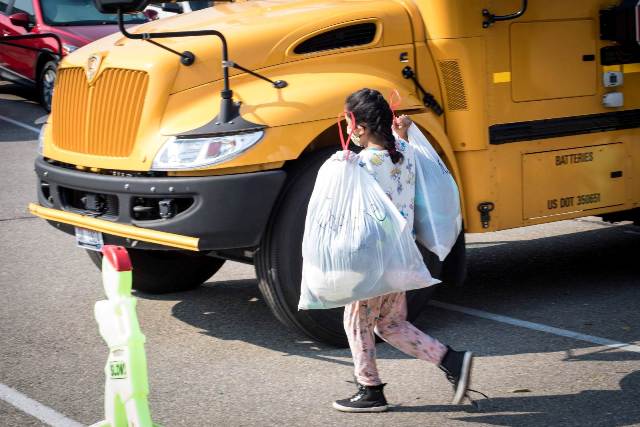 Student with a bag full of new clothing